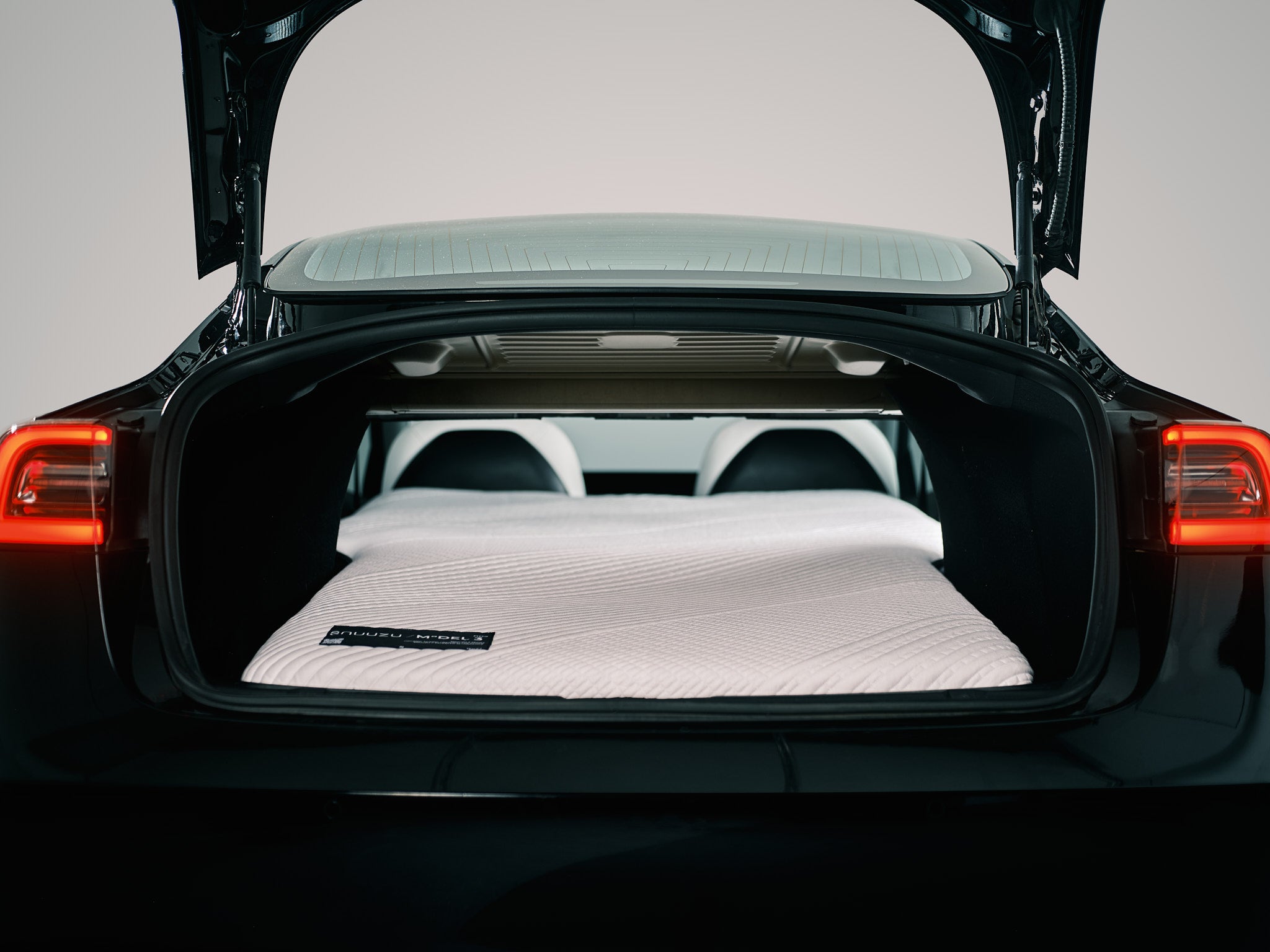 Snuuzu Tesla Model 3 camping mattress precision fit inside the rear trunk area creating a car camping bed