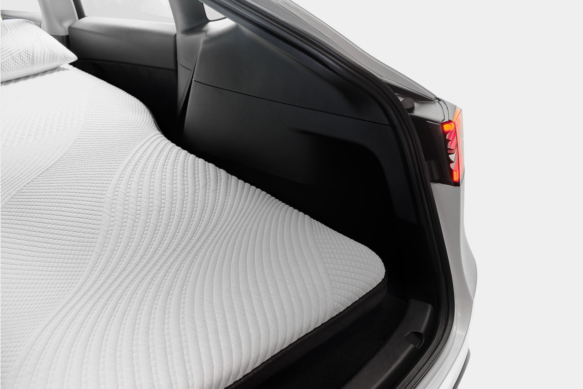 Snuuzu Tesla Model Y camping mattress showing precision custom fit inside the rear cargo area