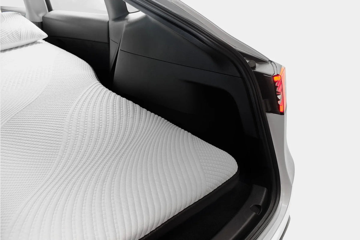 Snuuzu mattress filling the rear sleep area of a Tesla Model Y with the hatch open