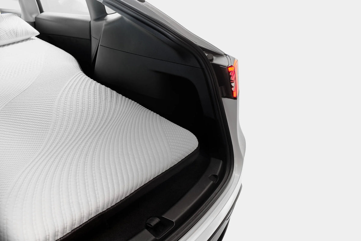 Tesla Model 3 trunk with a Snuuzu mattress fitted inside for car camping.
