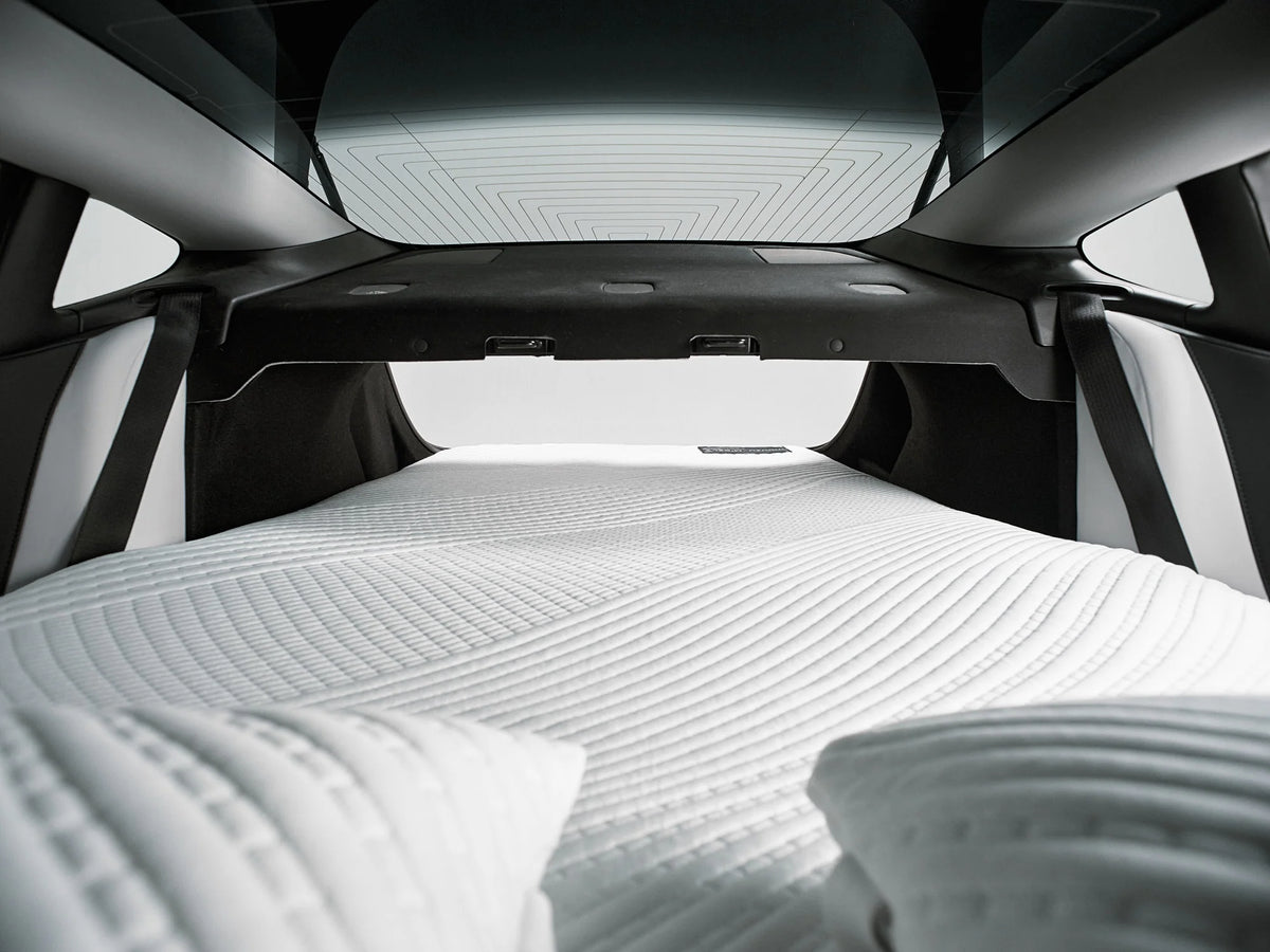 Close-up of the Snuuzu Tesla Model 3 mattress inflated inside the car, showing the fitted sleeping surface.
